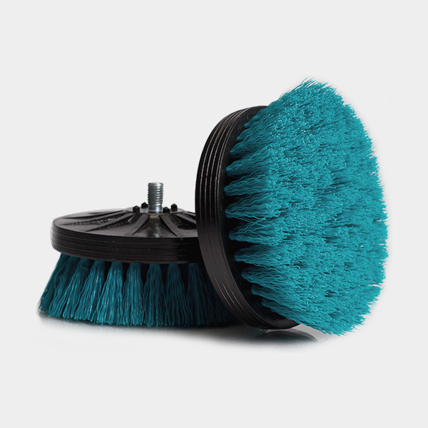 a blue brush sitting on top of a black stand.