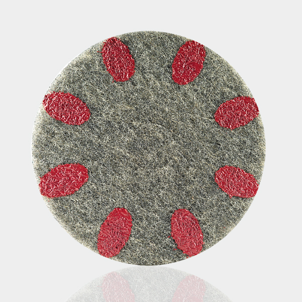 a round object with red circles on a white surface.