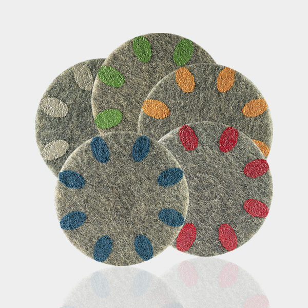 three circular coasters with colored dots on them.