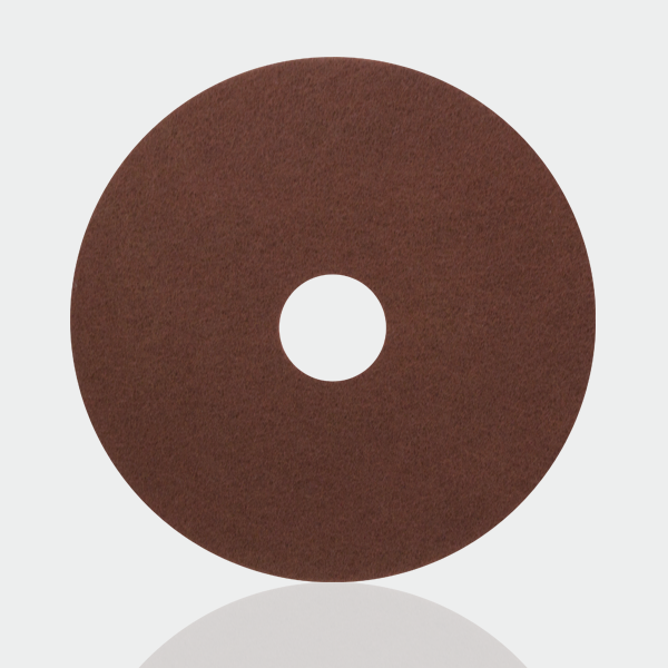 a brown polishing disc on a white background.