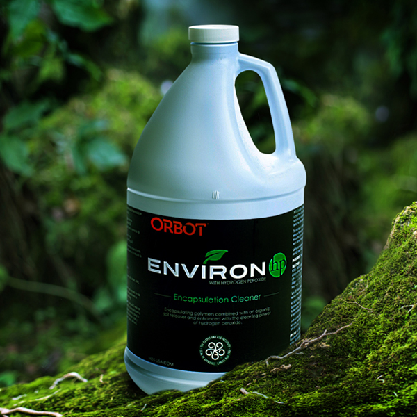 a gallon of environ is sitting on a moss covered tree.
